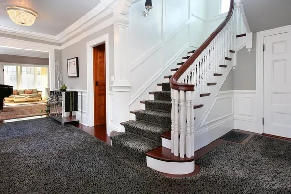 a view of entryway and hall with wooden floor