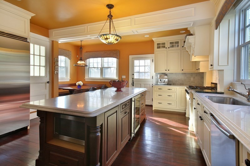 460 Heath Street Brookline, MA 02467 - Photo 3 of 22 a kitchen with stainless steel appliances granite countertop a stove a sink dishwasher and microwave with wooden floor