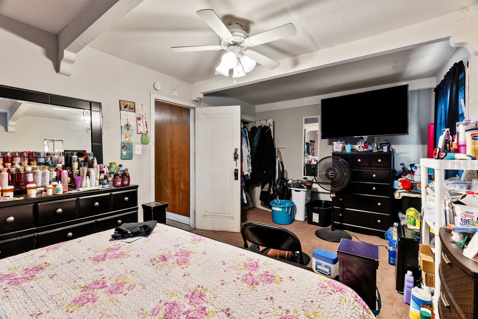910 Nicholson Street Joliet, IL 60435 - Photo 12 of 30 a bed room with a bed a flat screen tv and a ceiling fan