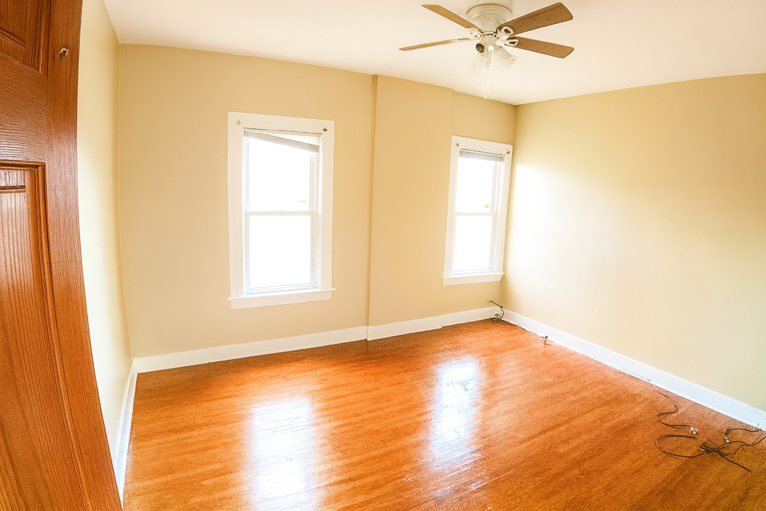 910 Nicholson Street Joliet, IL 60435 - Photo 22 of 30 a view of an empty room with wooden floor and a window