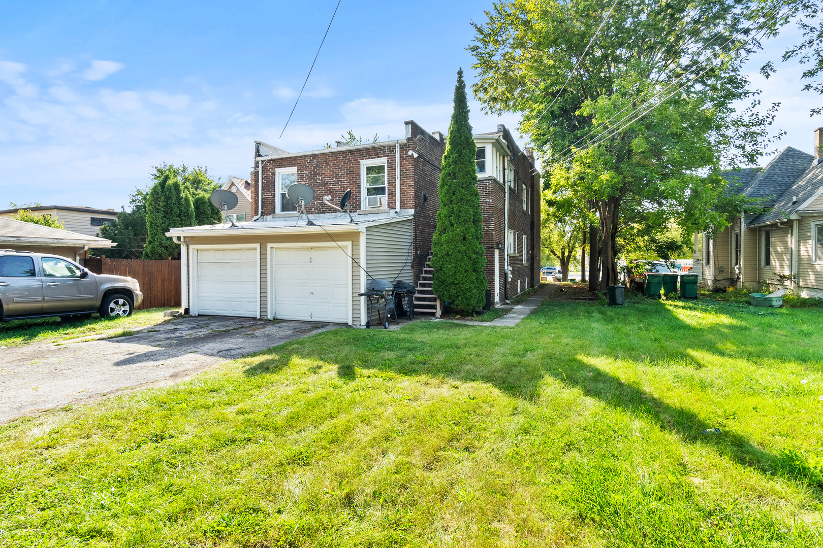 910 Nicholson Street Joliet, IL 60435 - Photo 3 of 30 a view of a house with backyard and a tree