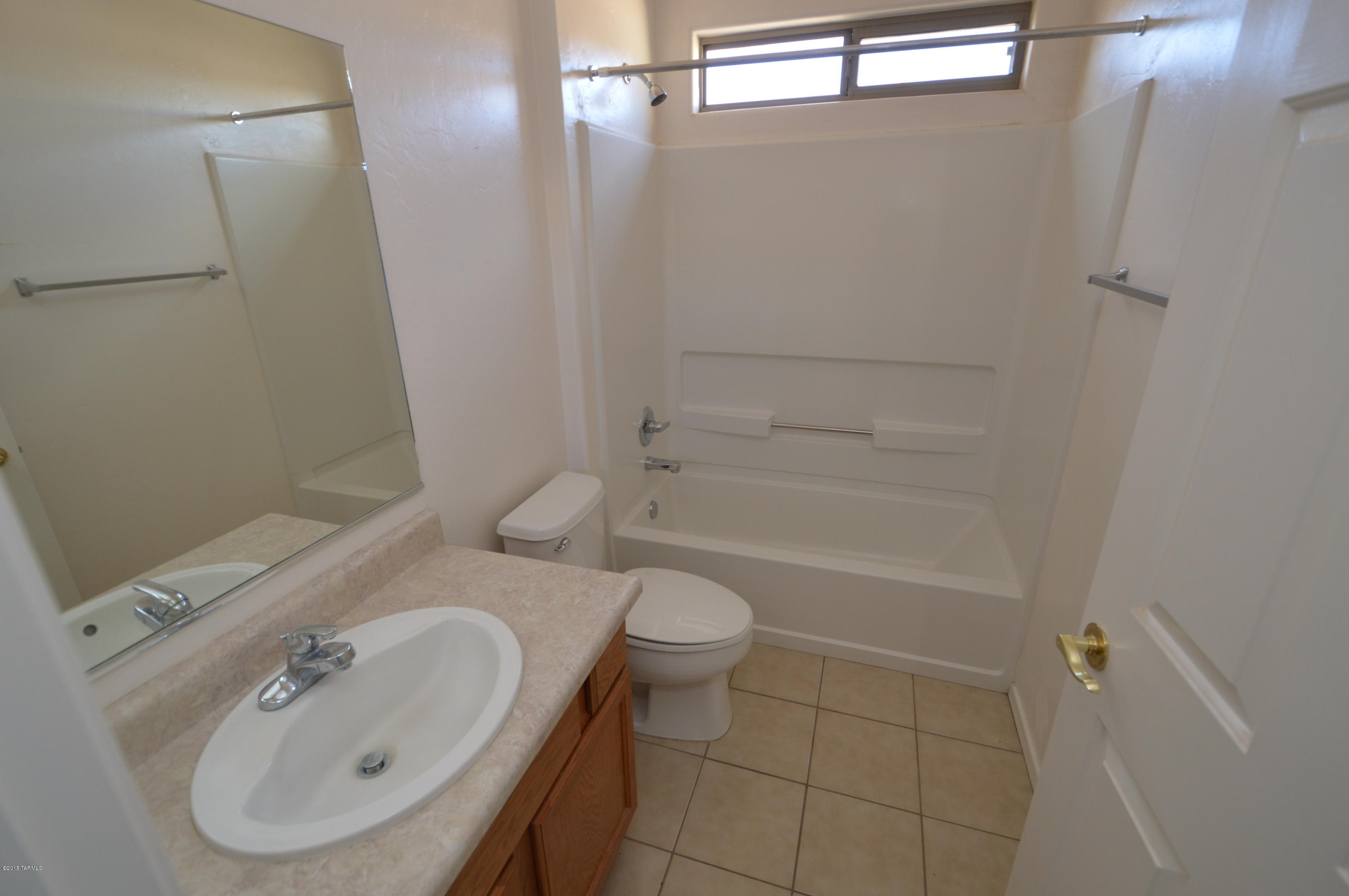 8396 West Benidorm Loop Tucson, AZ 85757 - Photo 11 of 13 a bathroom with a sink a toilet and shower