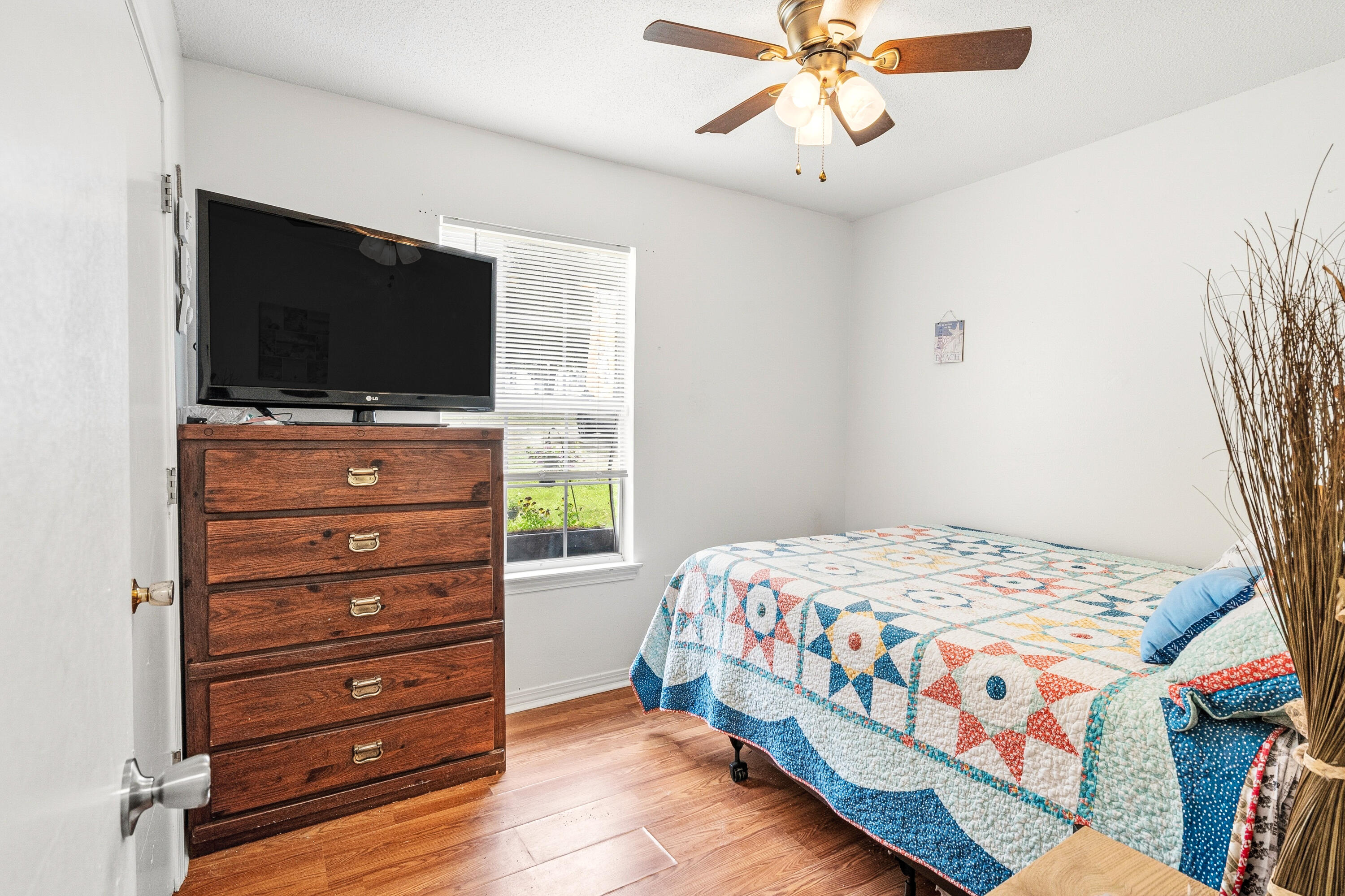 2880 Aplin Road Crestview, FL 32539 - Photo 17 of 33 a bedroom with a bed and a flat screen tv