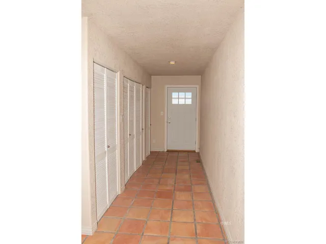 a view of a room with a ceiling fan