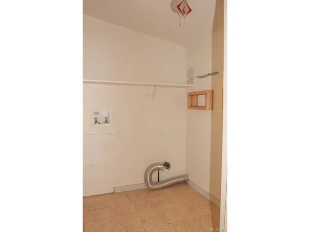 a kitchen with a refrigerator sink and cabinets
