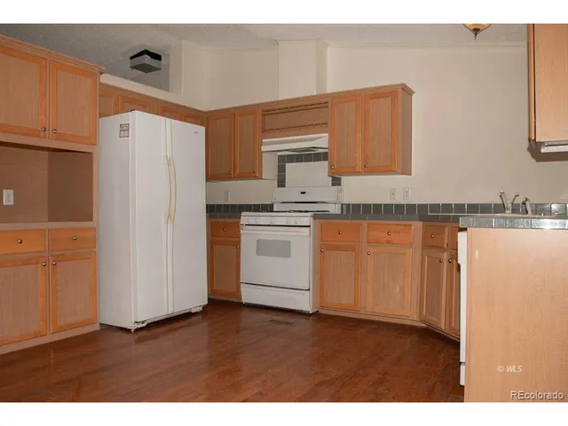 a view of a small space with wooden floor and a window