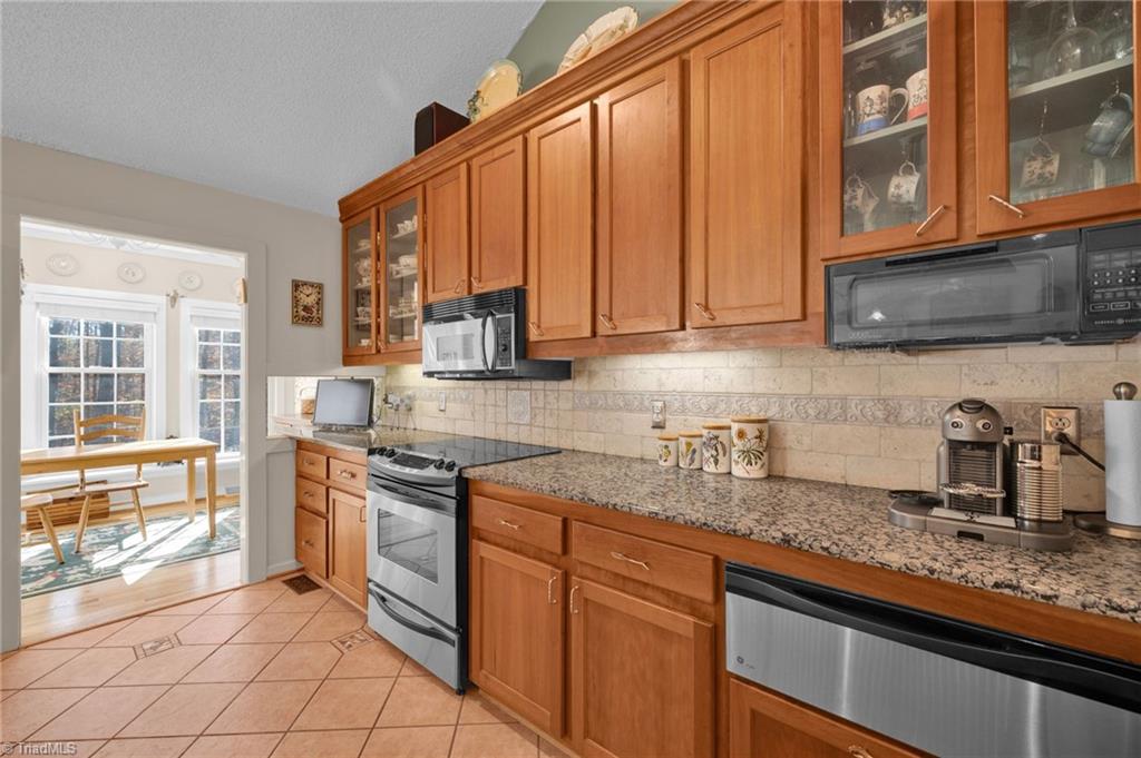 4300 Williams Road Lewisville, NC 27023 - Photo 13 of 50 Stainless steel appliances in addition to a warming drawer.
