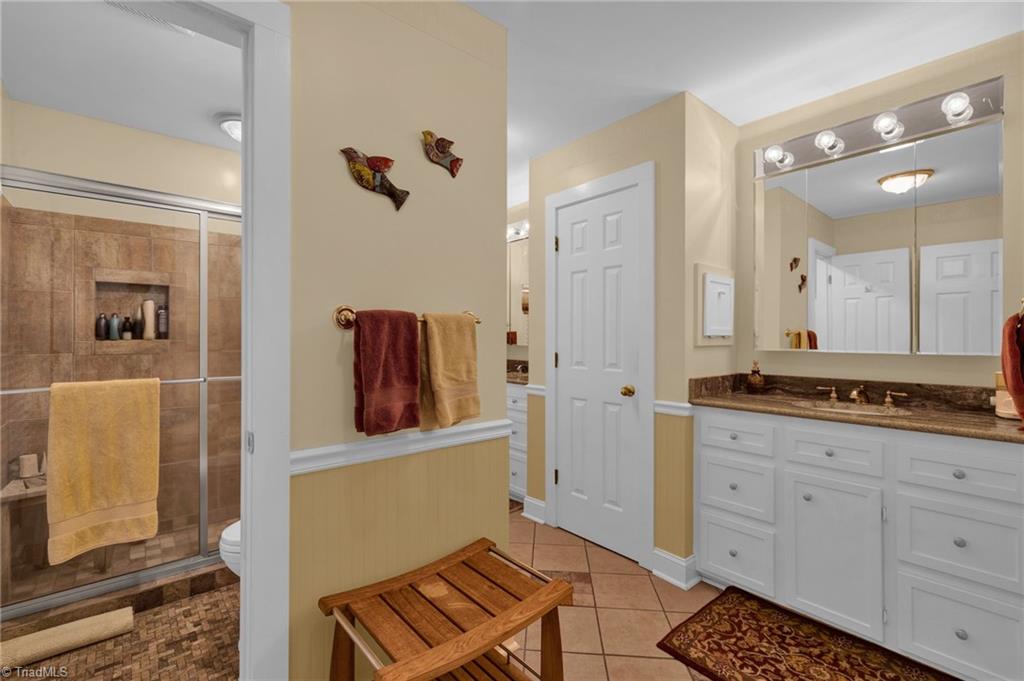 4300 Williams Road Lewisville, NC 27023 - Photo 18 of 50 Primary bath - tile shower and flooring, dual vanities