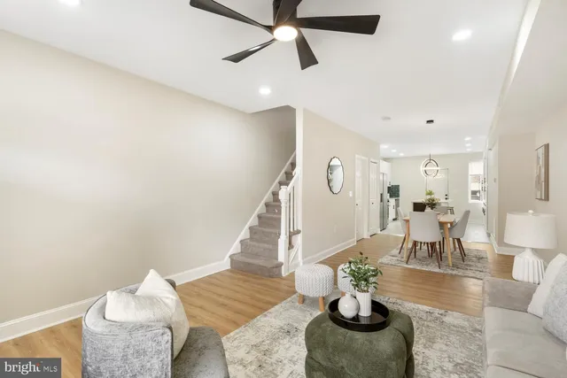 a living room with furniture and a potted plant