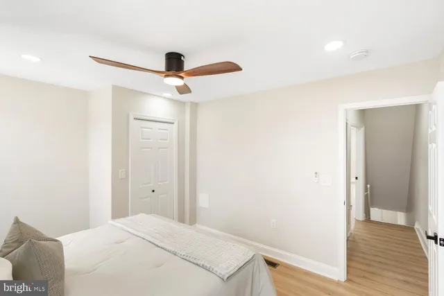 a bedroom with a bed and a ceiling fan