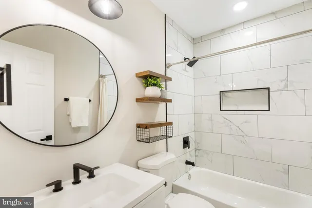 a bathroom with a sink a mirror and a bathtub