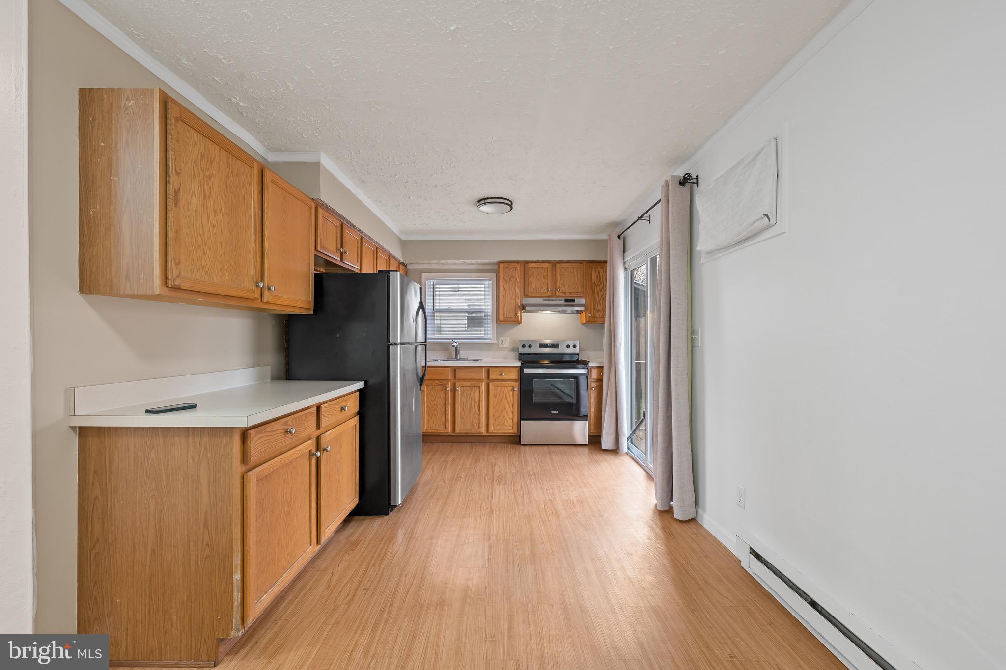163 East 2nd Street Alburtis, PA 18011 - Photo 16 of 30 a kitchen with stainless steel appliances granite countertop a stove a sink and a refrigerator
