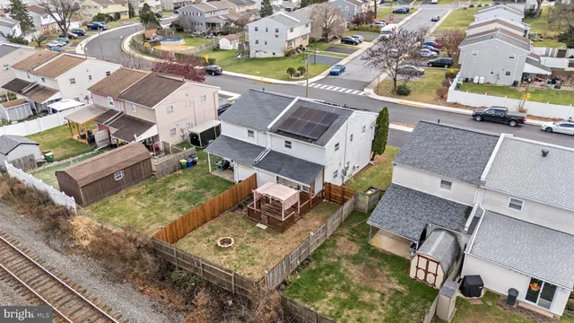 an aerial view of a house with garden space and street view