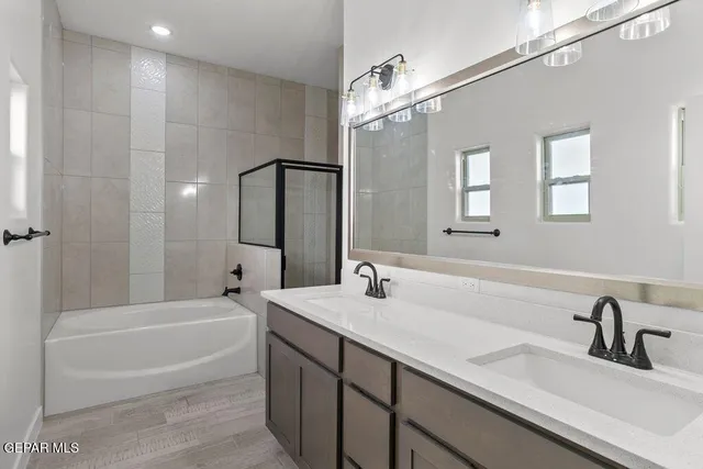 a bathroom with a tub sink and mirror