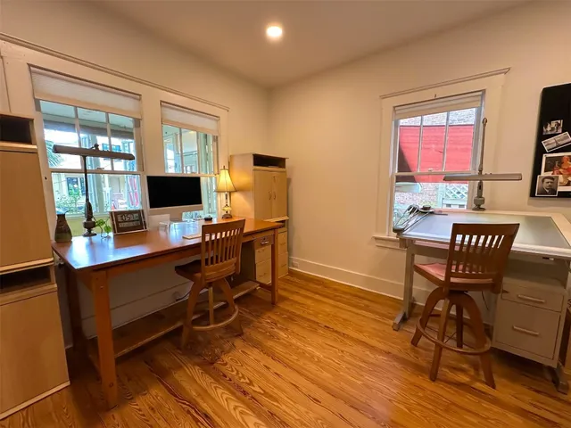 a view of a workspace with furniture and a window