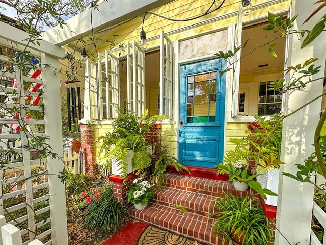 a view of a house with a flower garden