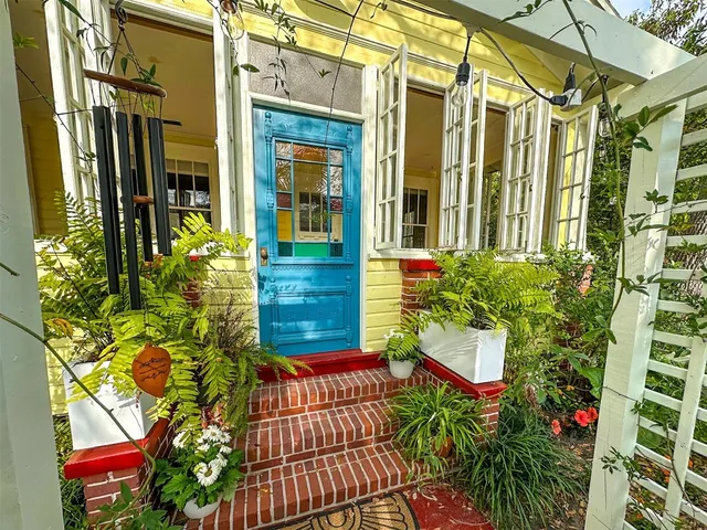 a view of a house with a flower garden