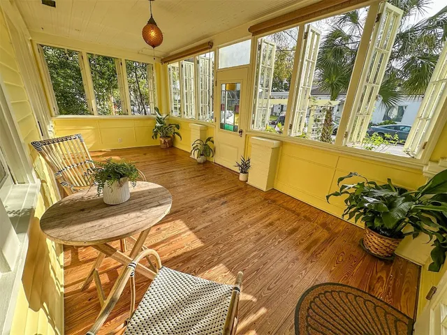 a living room with a couch and large windows