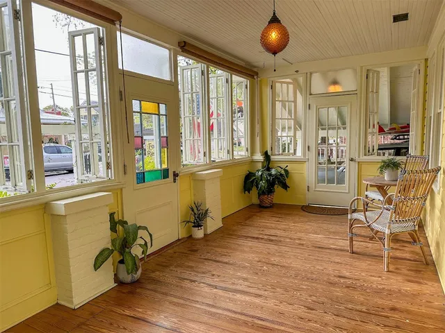 a view of a livingroom with furniture wooden floor and windows