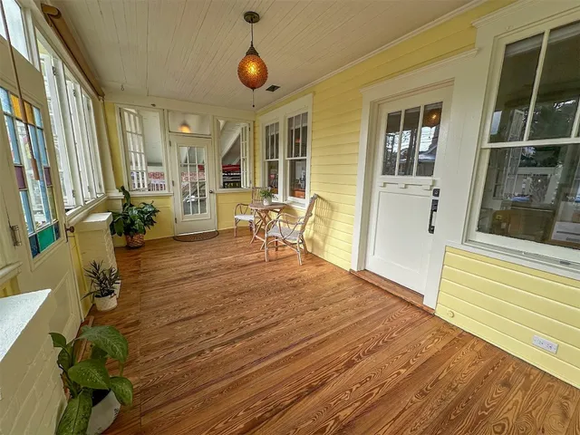 a room with wooden floor and furniture
