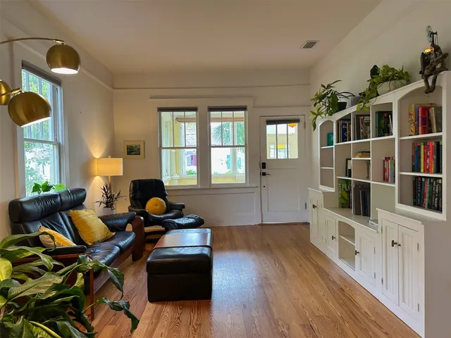 a living room with furniture windows and wooden floor