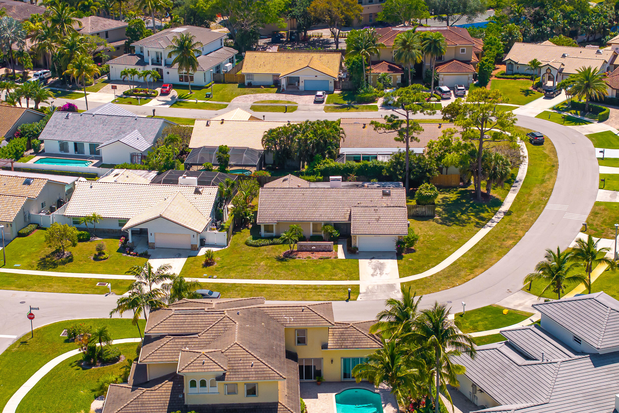 an aerial view of residential houses with outdoor space and swimming pool