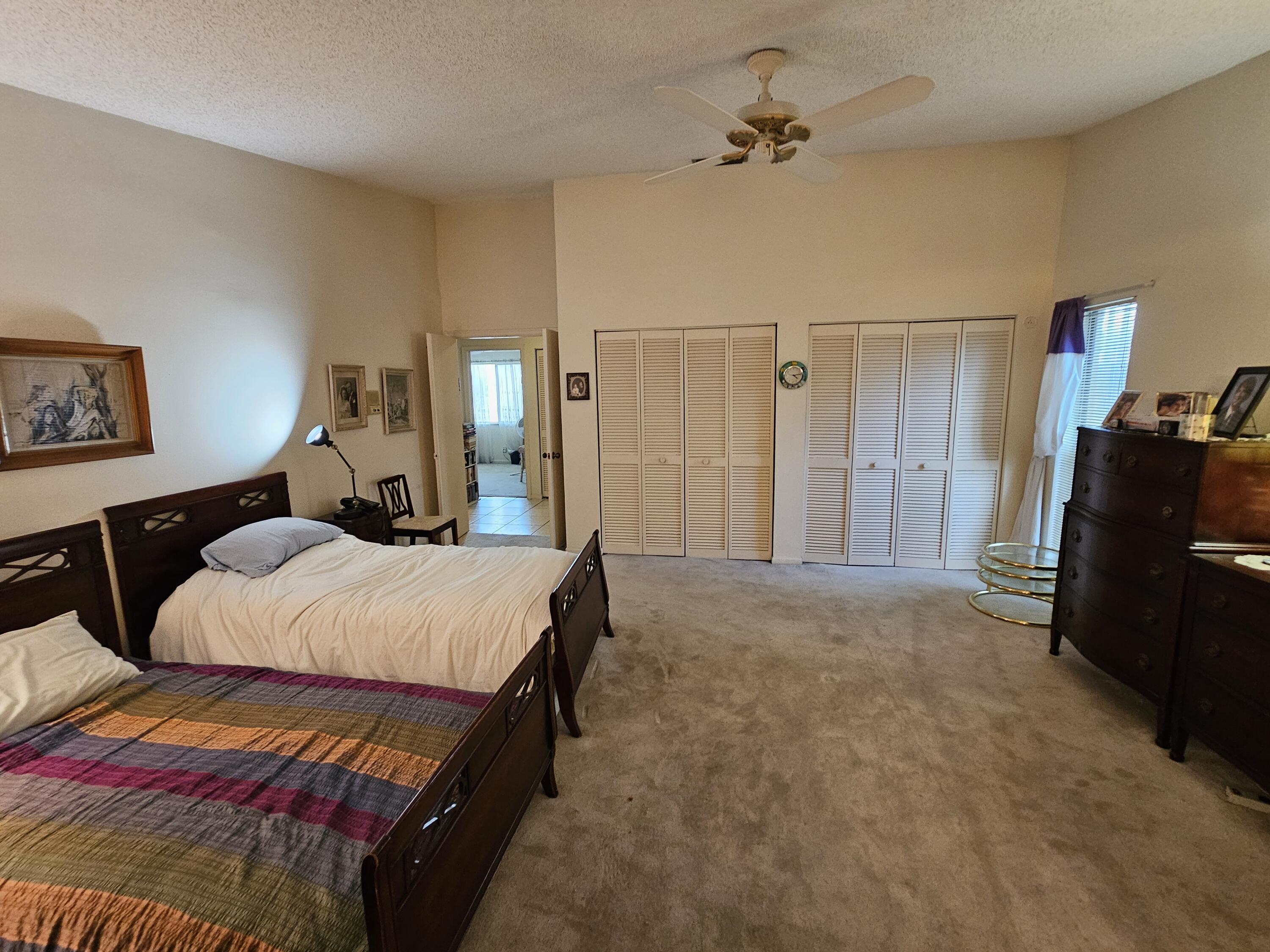 22171 Hollyhock Trail Boca Raton, FL 33433 - Photo 12 of 19 a bedroom with a bed and wooden floor