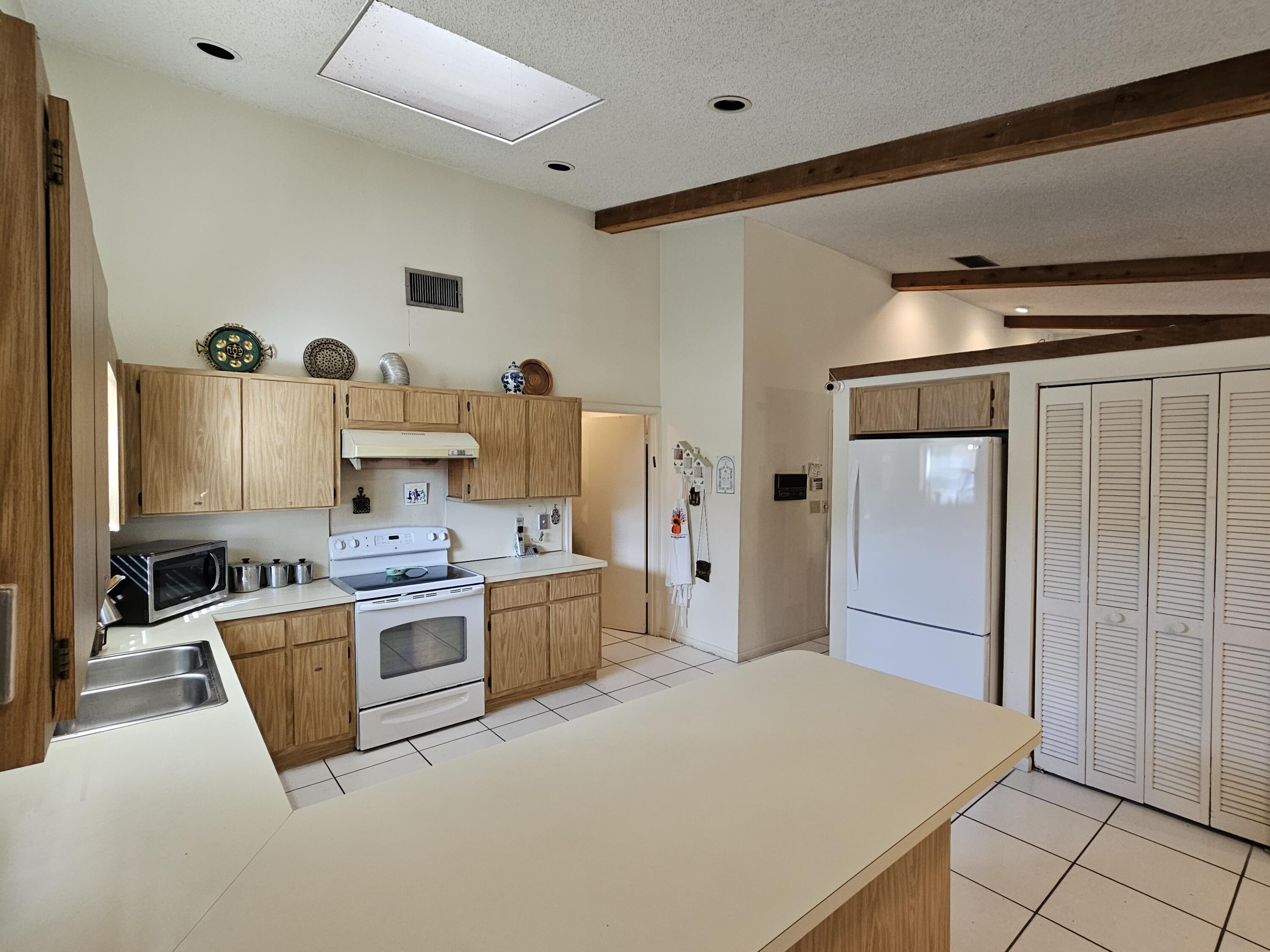 22171 Hollyhock Trail Boca Raton, FL 33433 - Photo 6 of 19 a kitchen with stainless steel appliances granite countertop a refrigerator a stove and a sink