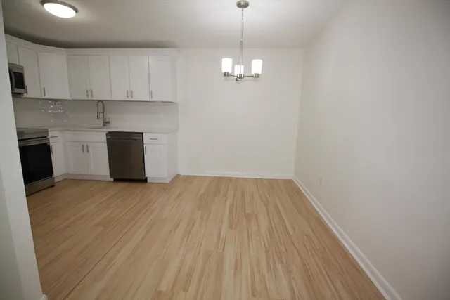 a view of kitchen and sink with wooden floor