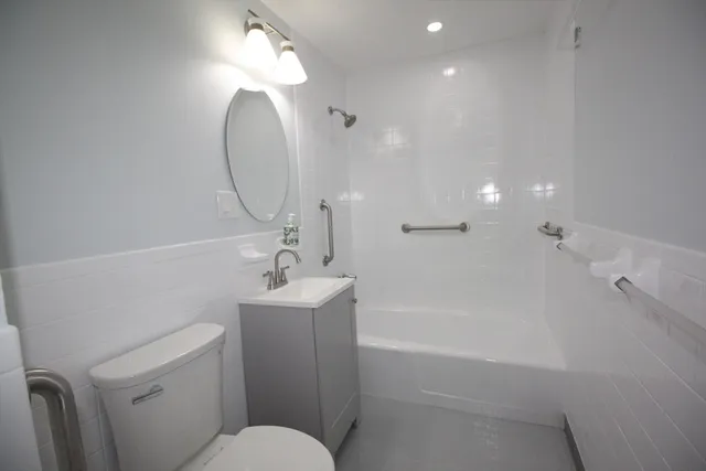 a bathroom with a sink a toilet and a mirror