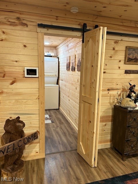 2445 McCord Hill Road Wellsburg, WV 26070 - Photo 11 of 37 Hall with wood walls, dark wood finished floors, a barn door, and stacked washer / drying machine