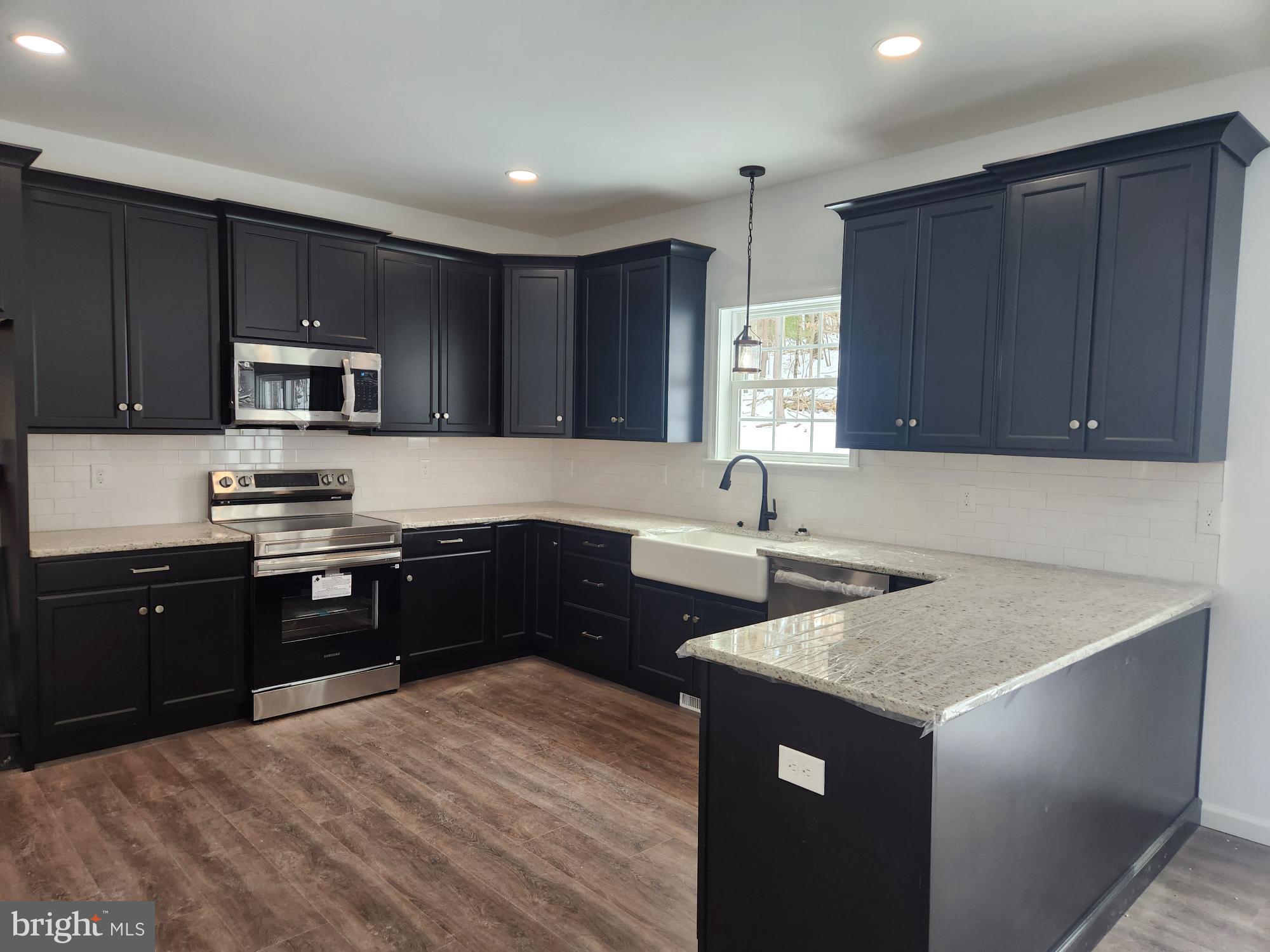 1929 Dunkleberger Road Elliottsburg, PA 17024 - Photo 4 of 48 Sleek modern kitchen with dark cabinetry.