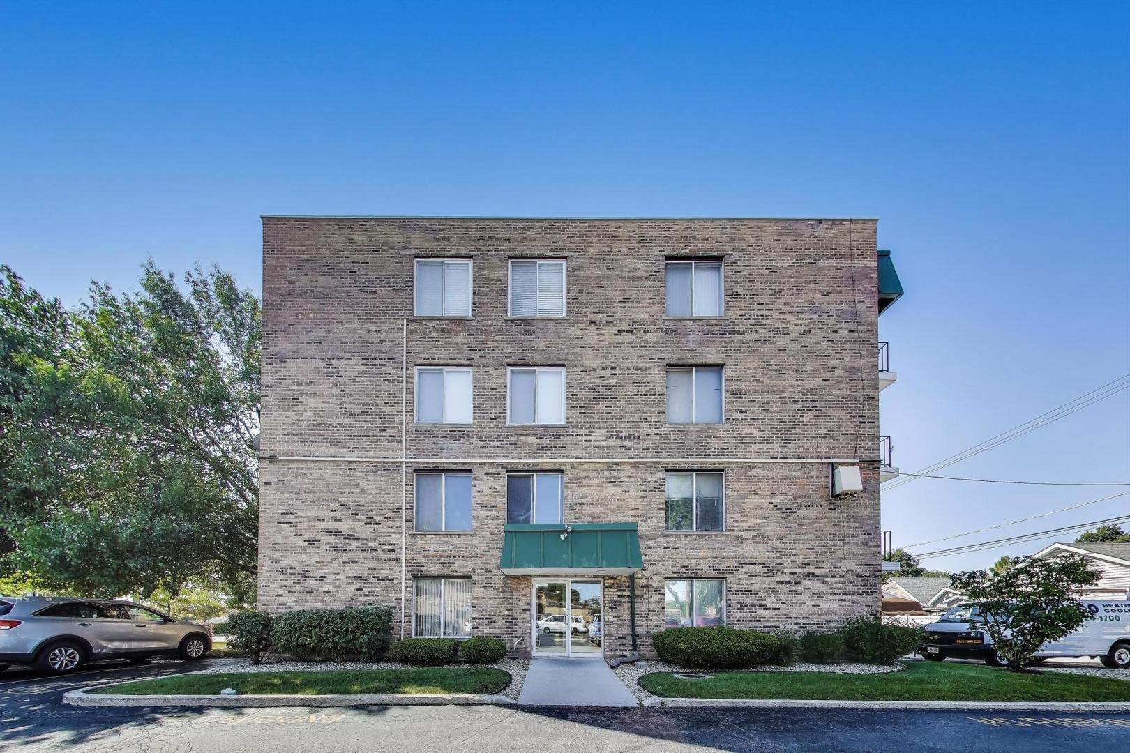 3838 West 111th Street, Unit 209 Chicago, IL 60655 - Photo 15 of 16 a brick building with a street