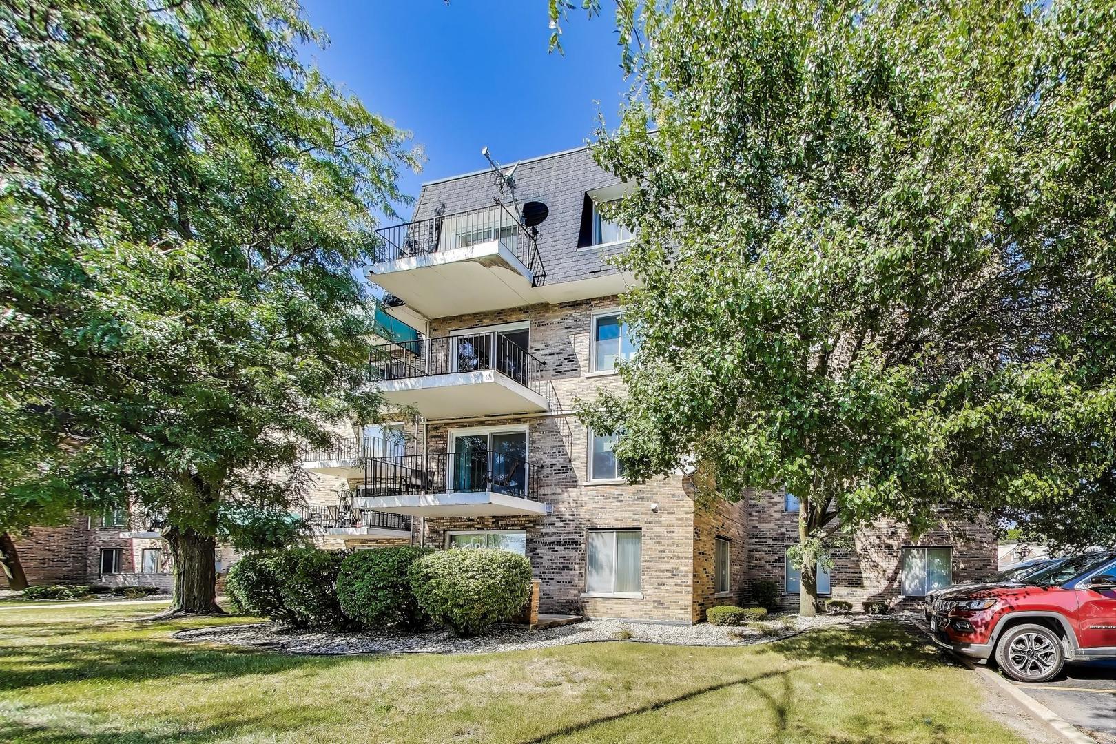 3838 West 111th Street, Unit 209 Chicago, IL 60655 - Photo 2 of 16 a view of a white house with a swimming pool