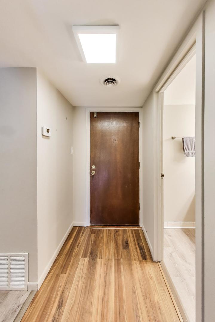3838 West 111th Street, Unit 209 Chicago, IL 60655 - Photo 4 of 16 a view of a hallway with wooden floor