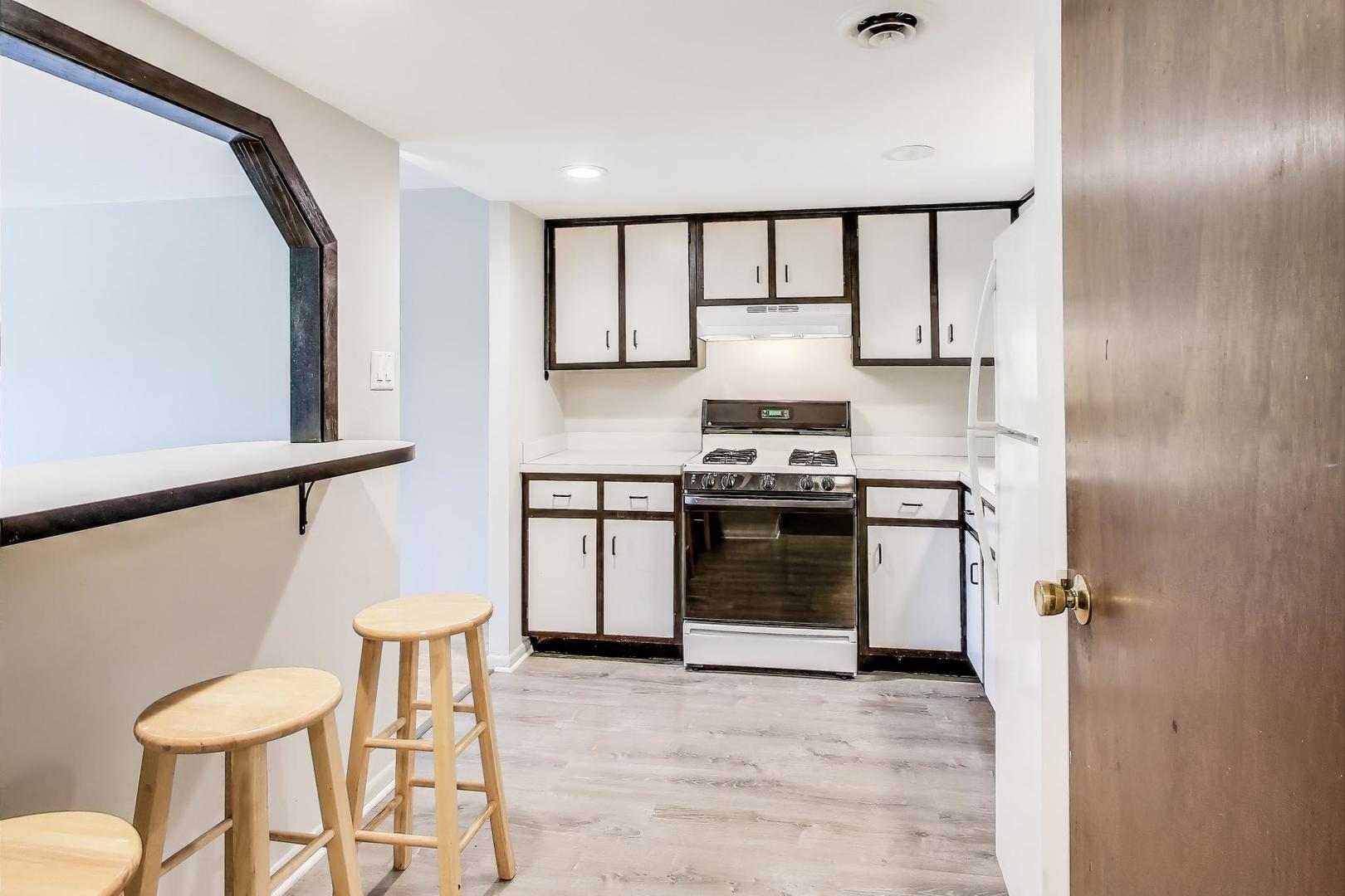 3838 West 111th Street, Unit 209 Chicago, IL 60655 - Photo 8 of 16 a kitchen with stainless steel appliances a stove a sink and a refrigerator