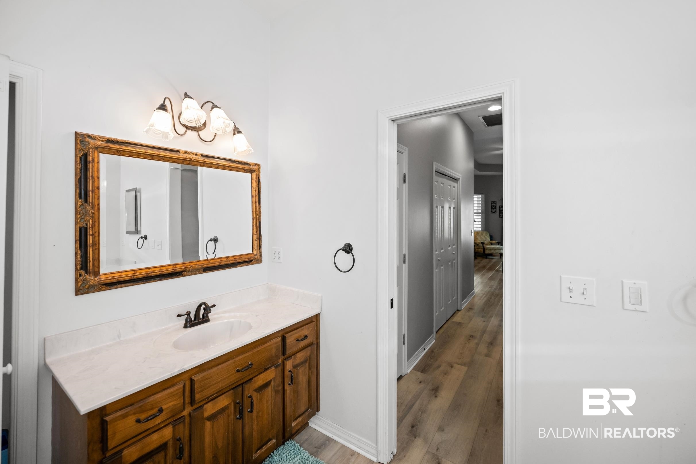 8585 Bay Harbor Road Elberta, AL 36530 - Photo 23 of 51 Bathroom with wood finished floors and vanity