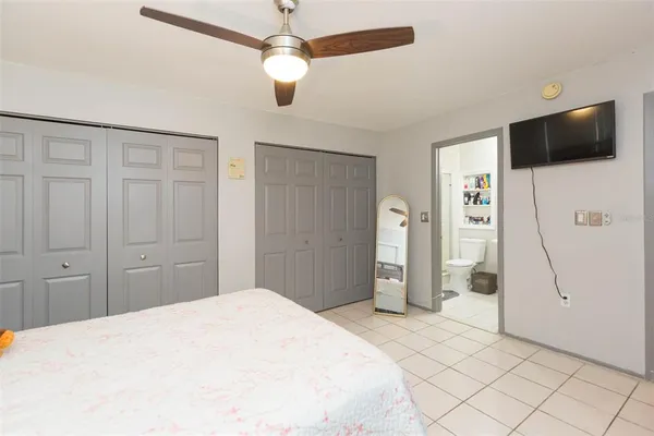 a bedroom with a bed and a flat screen tv