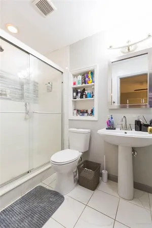 a bathroom with a sink toilet and shower