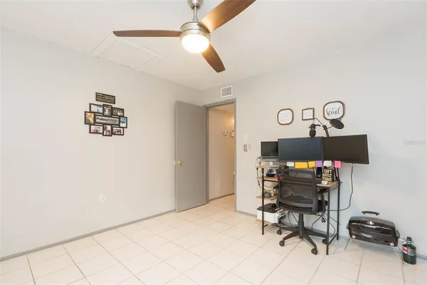 a workspace with furniture and a fan