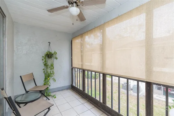 a view of a porch with furniture and a window