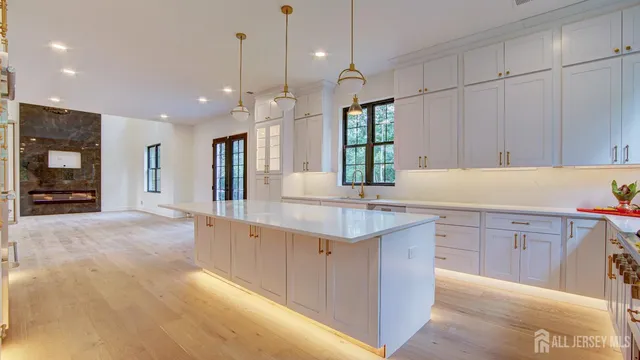 a large kitchen with a large counter top appliances and cabinets