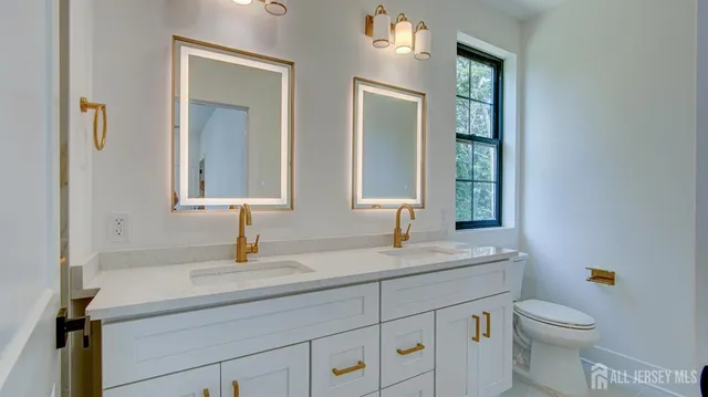 a bathroom with a granite countertop sink a mirror and a shower