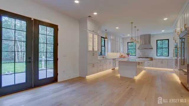 a large kitchen with granite countertop a large counter top stainless steel appliances and cabinets