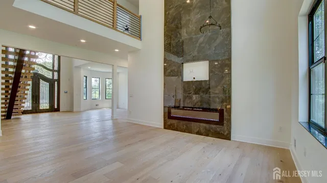 a view of a livingroom with wooden floor and entrance