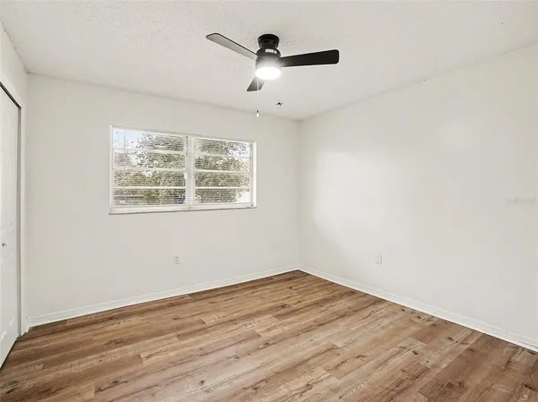 a bathroom with a toilet sink vanity and mirror