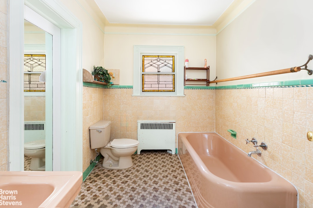 1917 Glenwood Road Brooklyn, NY 11230 - Photo 13 of 22 a bathroom with a toilet a sink and bathtub