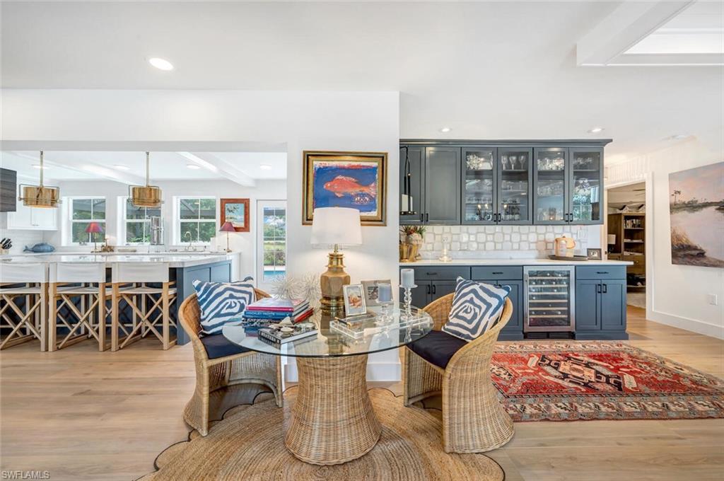 200 Burning Tree Drive Naples, FL 34105 - Photo 10 of 48 a dinning room with furniture a rug and kitchen view