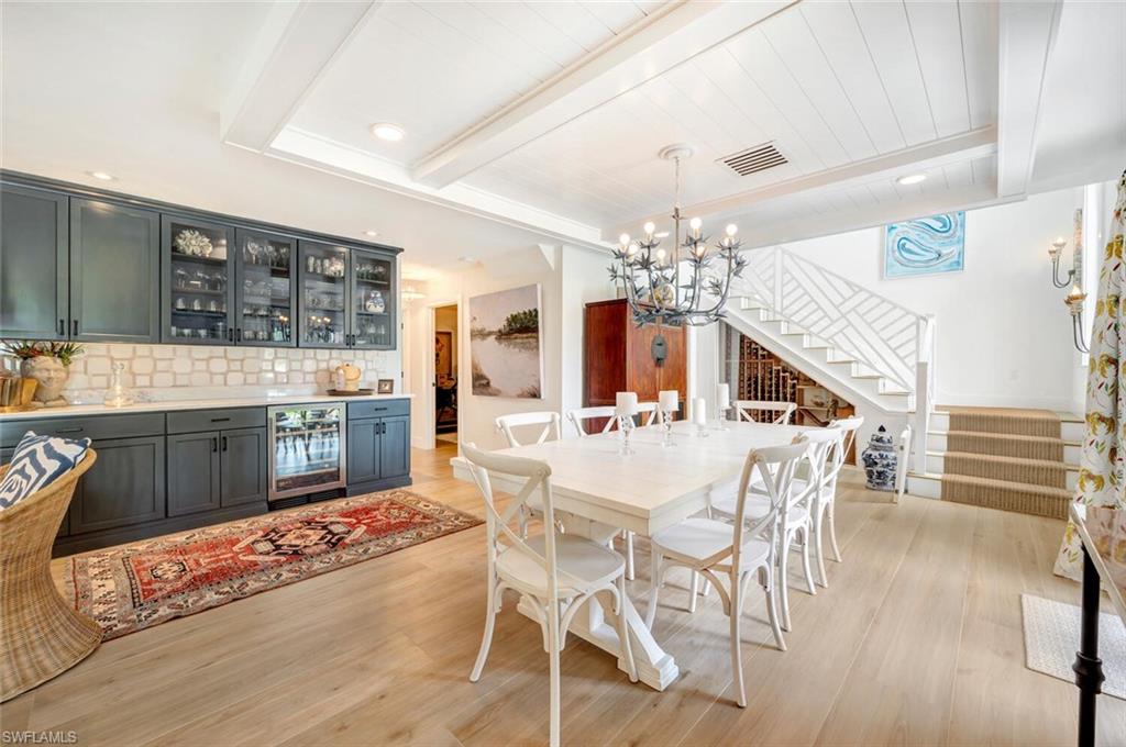 200 Burning Tree Drive Naples, FL 34105 - Photo 11 of 48 a view of a dining room with furniture and chandelier