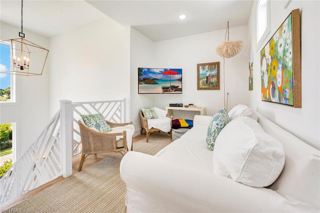 200 Burning Tree Drive Naples, FL 34105 - Photo 28 of 48 a bedroom with a bed and a painting on the wall